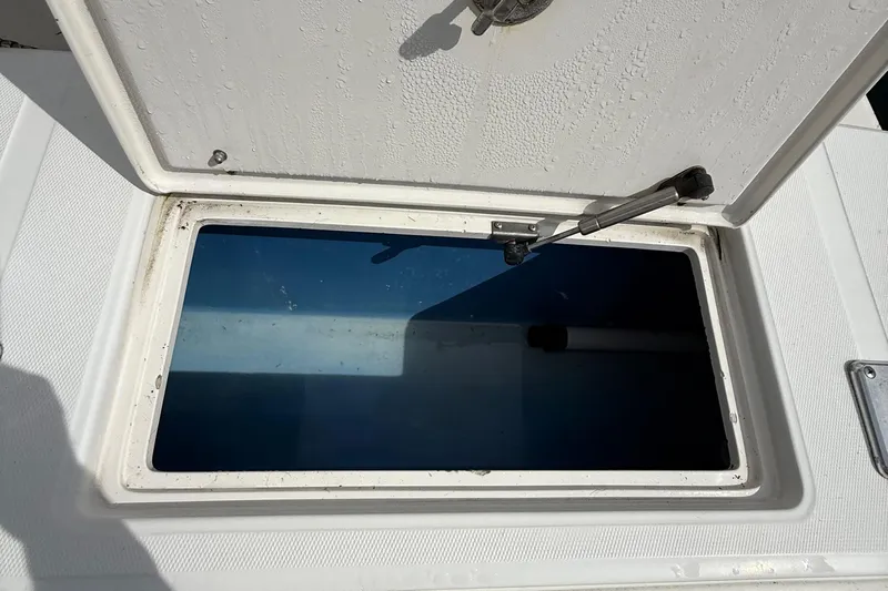  Yacht Photos Pics Open storage compartment on a 2007 Jupiter 31 boat, showing interior details.