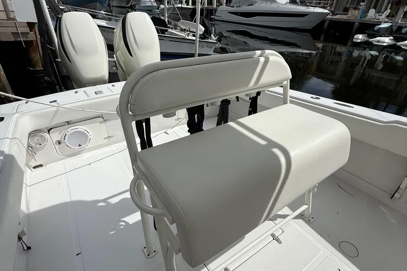  Yacht Photos Pics 2007 Jupiter 31 boat interior with white seating and dual engines at dock.