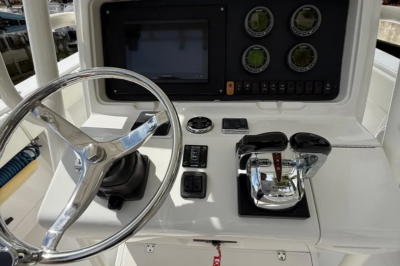  Yacht Photos Pics Control panel of a 2007 Jupiter 31 boat with steering wheel and gauges.
