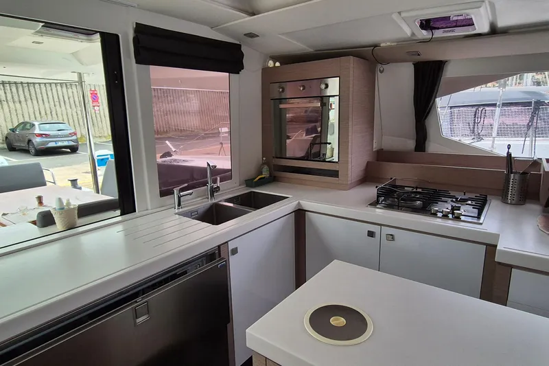  Yacht Photos Pics Modern kitchen interior of 2021 Fountaine Pajot Saona 47 catamaran with sleek appliances.