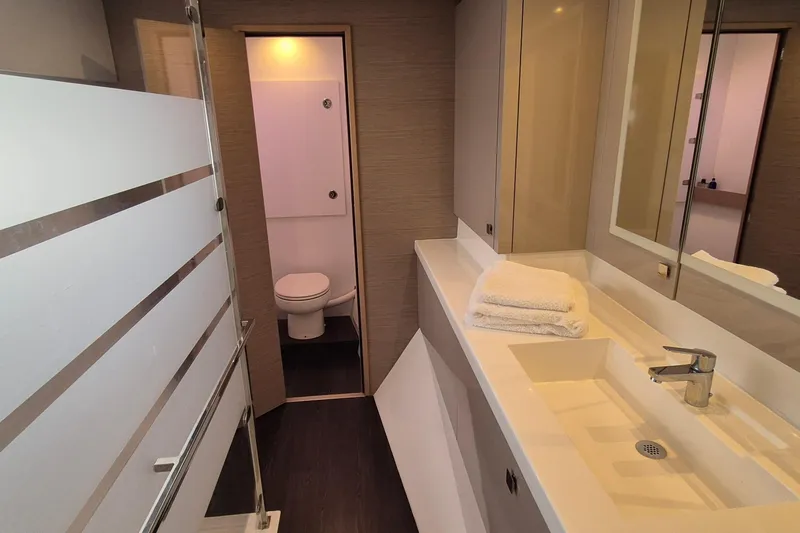  Yacht Photos Pics Luxurious bathroom in 2021 Fountaine Pajot Saona 47 yacht with modern fixtures and elegant design.