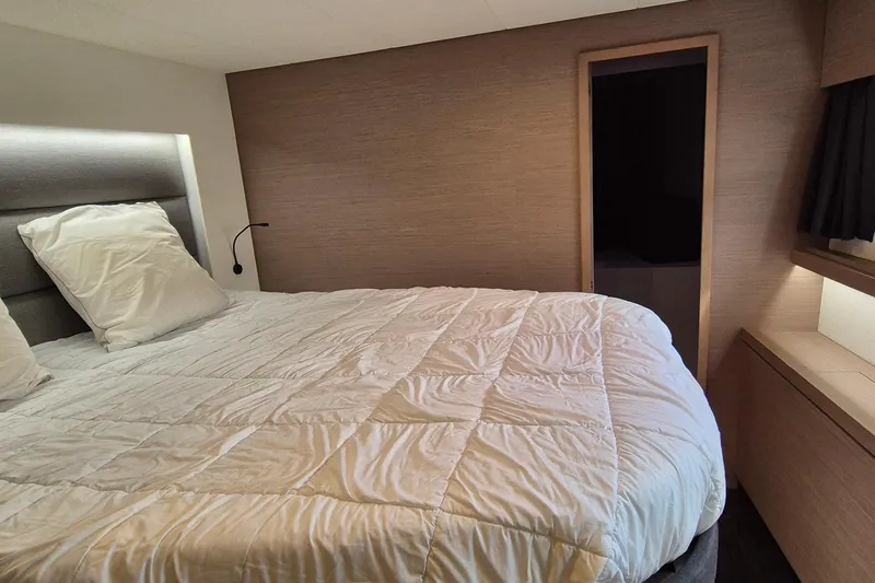  Yacht Photos Pics Luxurious bedroom interior of 2021 Fountaine Pajot Saona 47 catamaran with cozy bedding.