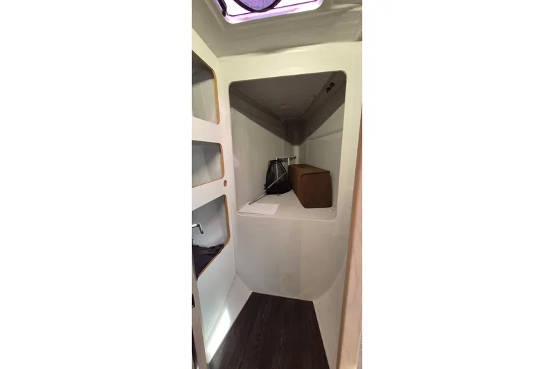  Yacht Photos Pics Interior cabin of 2021 Fountaine Pajot Saona 47 catamaran, featuring storage shelves and modern design.