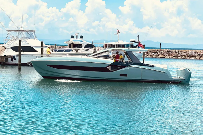  Yacht Photos Pics 2025 Azimut Verve 48 yacht cruising in a marina under a clear blue sky.