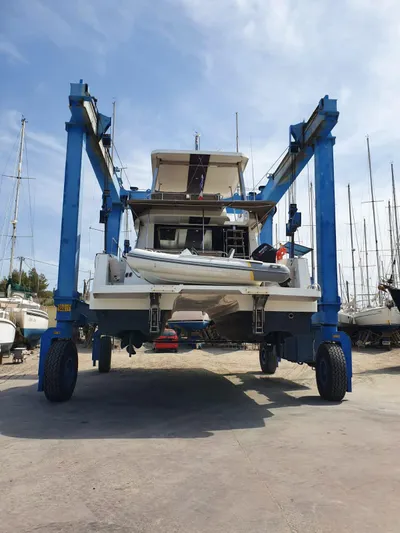  Yacht Photos Pics 2016 Fountaine Pajot MY 37 catamaran on a boat lift in a marina.