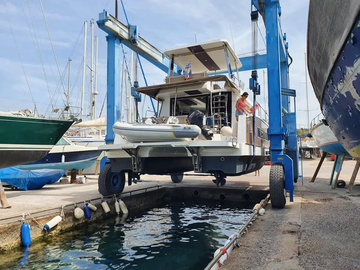  Yacht Photos Pics Fountaine Pajot MY 37 yacht being lifted at a marina, 2016 model.