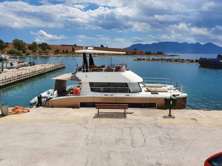  Yacht Photos Pics 2016 Fountaine Pajot MY 37 yacht docked at a scenic marina with mountains in the background.