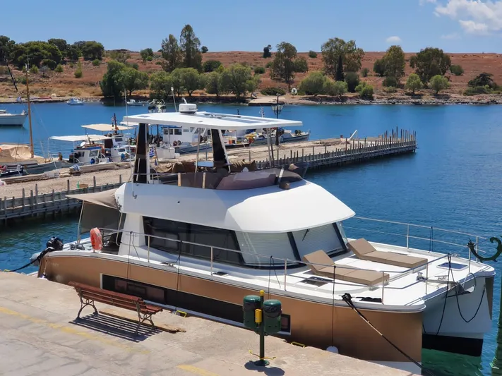  Yacht Photos Pics 2016 Fountaine Pajot MY 37 yacht docked at a scenic marina with clear blue water.