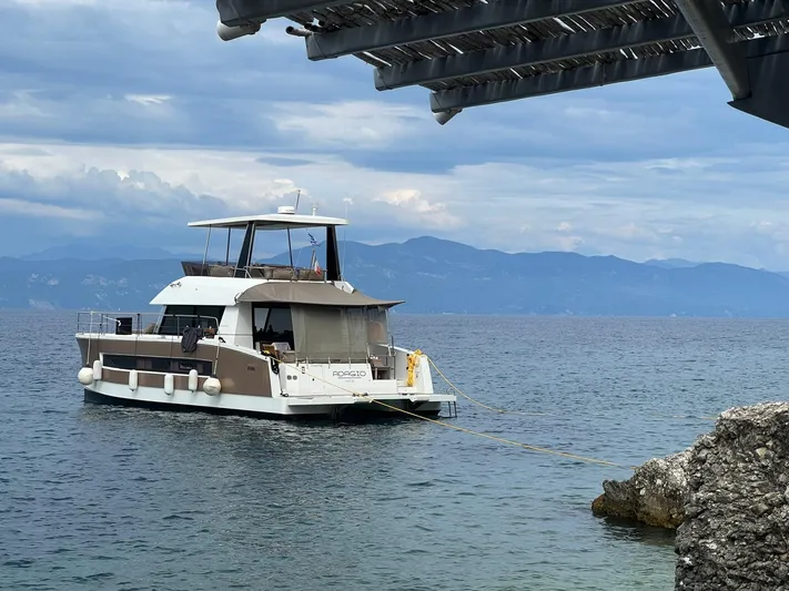  Yacht Photos Pics 2016 Fountaine Pajot MY 37 yacht anchored on a serene lake with mountainous backdrop.