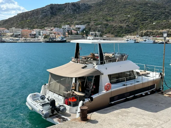  Yacht Photos Pics 2016 Fountaine Pajot MY 37 yacht docked in a scenic harbor with hills in the background.