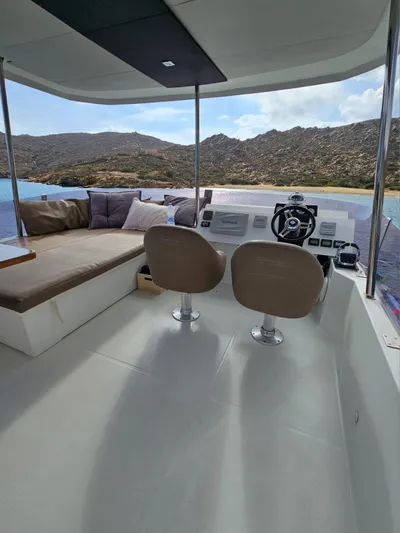  Yacht Photos Pics 2016 Fountaine Pajot MY 37 yacht interior with helm, seating, and scenic coastal view.