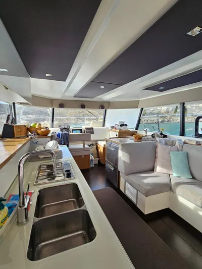  Yacht Photos Pics Interior of 2016 Fountaine Pajot MY 37 yacht with modern kitchen and seating area.