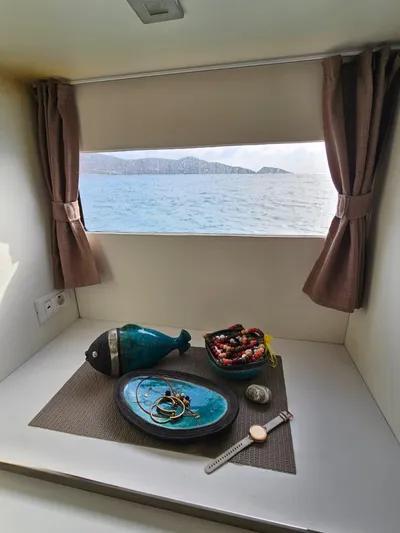  Yacht Photos Pics Interior of 2016 Fountaine Pajot MY 37 with sea view, decorative items, and brown curtains.