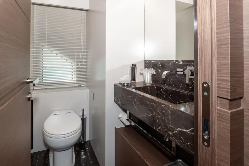 Willpower Yacht Photos Pics Luxurious bathroom in 2018 FERETTI Navetta 37 yacht with marble sink and modern fixtures.