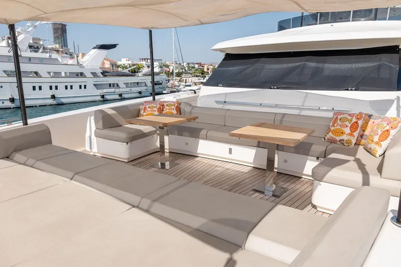 Willpower Yacht Photos Pics Luxurious 2018 FERETTI Navetta 37 yacht deck with seating and tables, docked in marina.