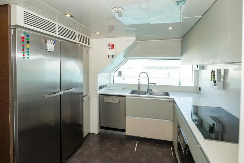 Willpower Yacht Photos Pics Modern kitchen interior on 2018 FERETTI Navetta 37 yacht, featuring sleek appliances and ample counter space.