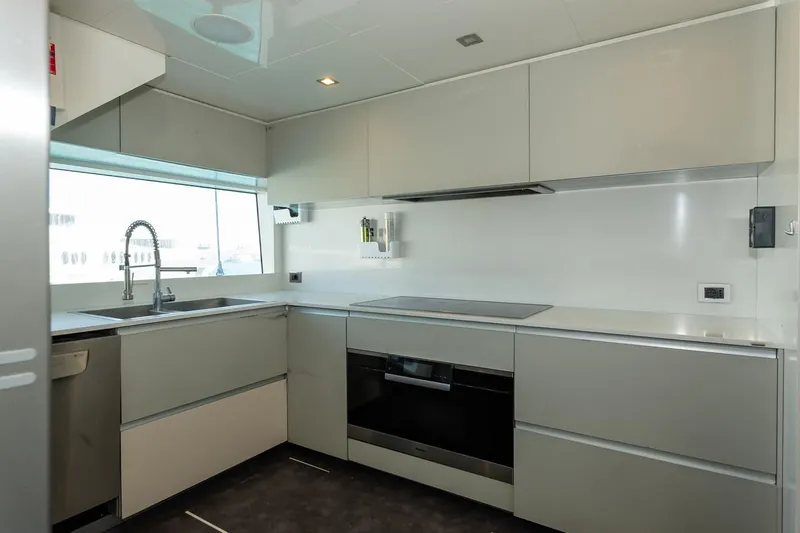 Willpower Yacht Photos Pics Modern kitchen interior on 2018 FERETTI Navetta 37 yacht, featuring sleek cabinetry and appliances.