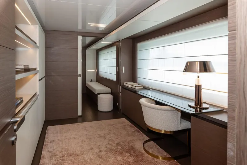 Willpower Yacht Photos Pics Luxurious interior of 2018 FERETTI Navetta 37 yacht with modern desk and seating area.