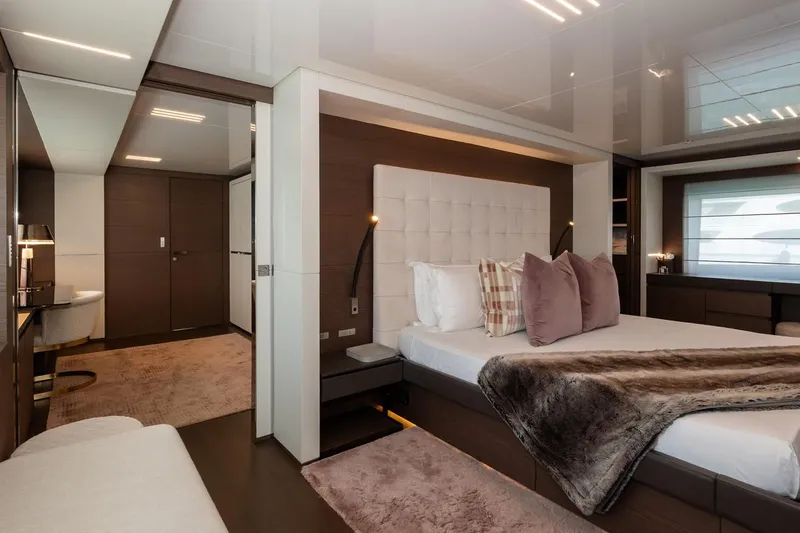 Willpower Yacht Photos Pics Luxurious bedroom interior on 2018 FERETTI Navetta 37 yacht, featuring elegant decor and plush bedding.