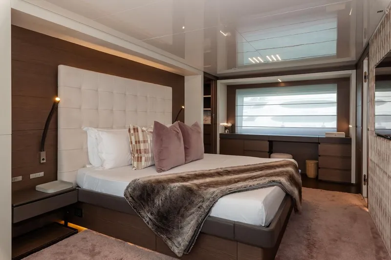 Willpower Yacht Photos Pics Luxurious bedroom interior on 2018 FERETTI Navetta 37 yacht, featuring elegant decor and plush bedding.