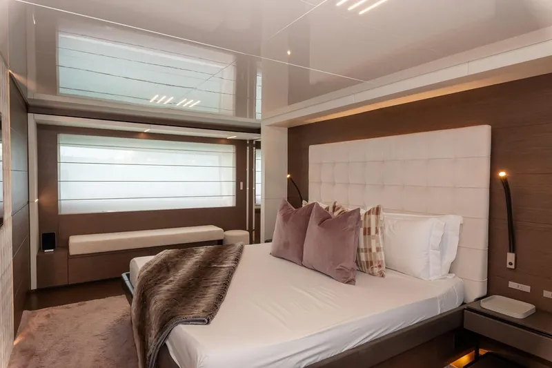 Willpower Yacht Photos Pics Luxurious bedroom interior on 2018 FERETTI Navetta 37 yacht, featuring elegant decor and plush bedding.