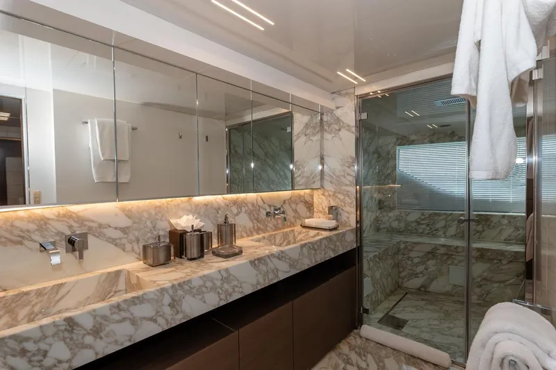 Willpower Yacht Photos Pics Luxurious marble bathroom on 2018 FERETTI Navetta 37 yacht with modern fixtures and glass shower.