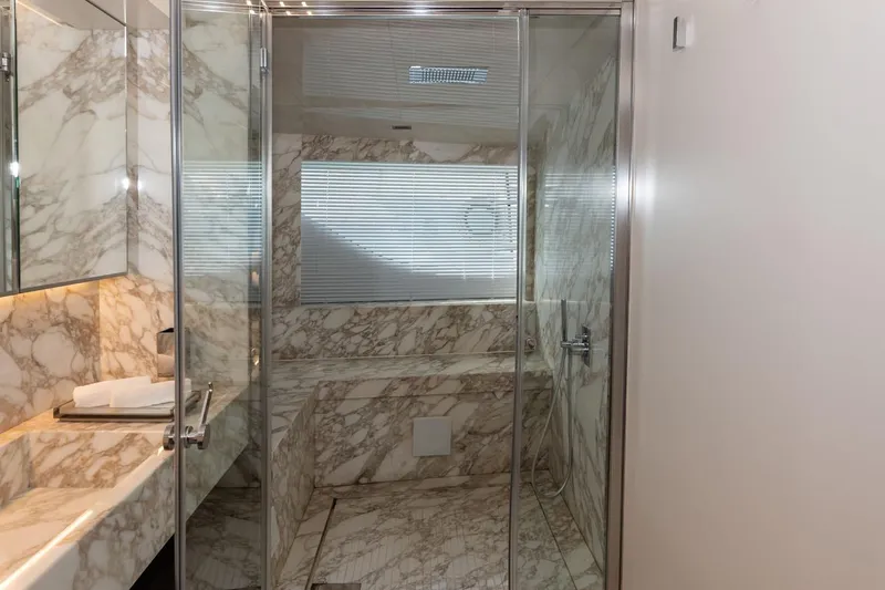 Willpower Yacht Photos Pics Luxurious marble bathroom in 2018 FERETTI Navetta 37 yacht, featuring glass shower enclosure.