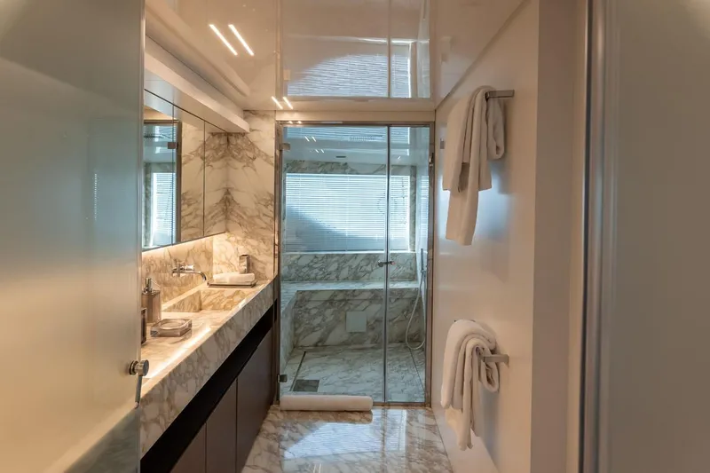 Willpower Yacht Photos Pics Luxurious marble bathroom in 2018 FERETTI Navetta 37 yacht, featuring elegant fixtures and towels.