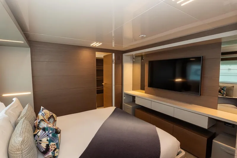 Willpower Yacht Photos Pics Luxurious bedroom interior of 2018 FERETTI Navetta 37 yacht with modern decor and large TV.