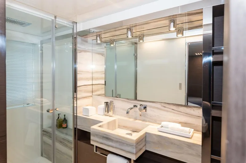 Willpower Yacht Photos Pics Luxurious bathroom on 2018 FERETTI Navetta 37 yacht with marble sink and glass shower.