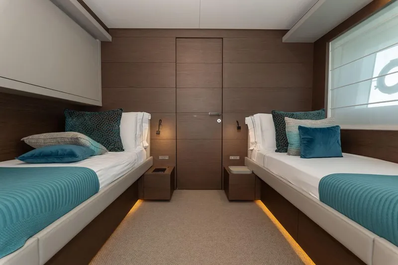 Willpower Yacht Photos Pics Luxurious twin cabin interior on 2018 FERETTI Navetta 37 yacht, featuring elegant bedding and modern design.