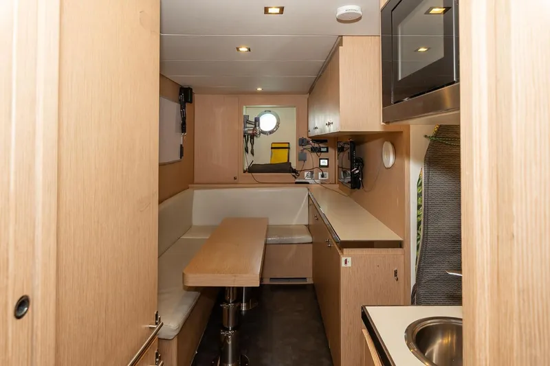 Willpower Yacht Photos Pics Interior of 2018 FERETTI Navetta 37 yacht, featuring a compact kitchen and dining area.