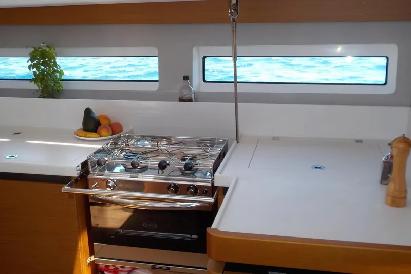  Yacht Photos Pics Modern kitchen interior of 2020 Jeanneau Sun Odyssey 490 yacht with ocean view.