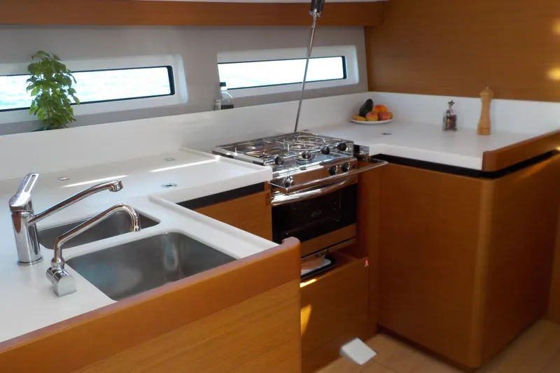  Yacht Photos Pics Modern kitchen in 2020 Jeanneau Sun Odyssey 490 yacht with stove and sink.