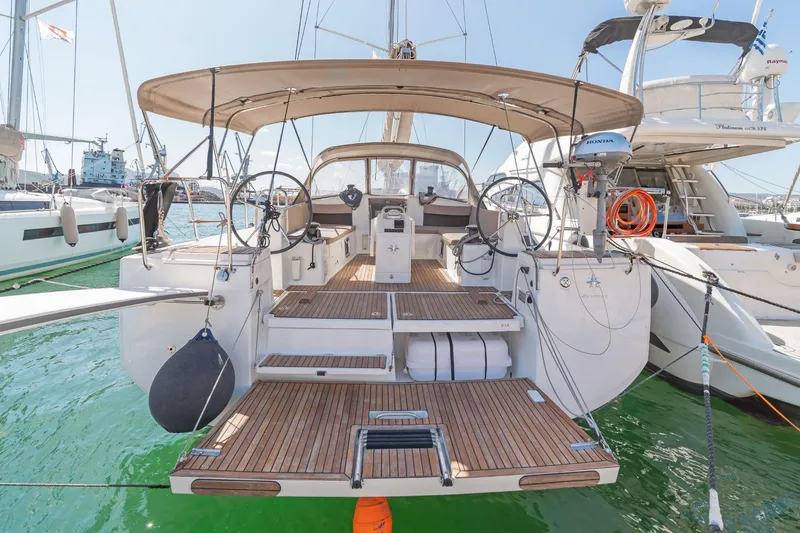  Yacht Photos Pics 2020 Jeanneau Sun Odyssey 490 yacht docked, showcasing spacious deck and dual steering wheels.