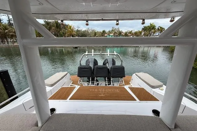  Yacht Photos Pics 2024 Axopar 37 Sun-Top boat interior with seating, overlooking a serene waterway.