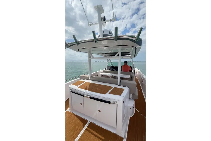  Yacht Photos Pics 2024 Axopar 37 Sun-Top boat on water, featuring spacious deck and modern design.