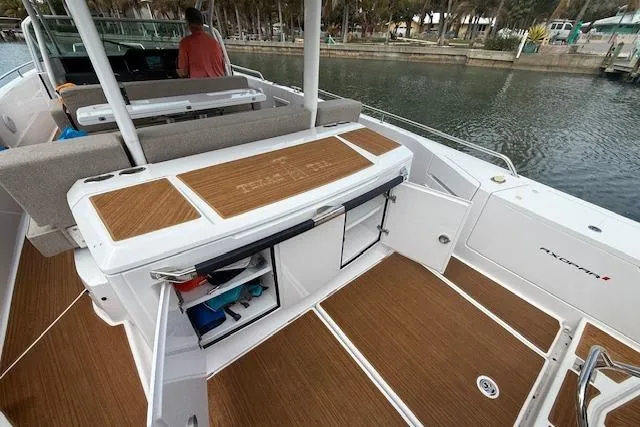  Yacht Photos Pics 2024 Axopar 37 Sun-Top boat interior with teak flooring and storage compartments.