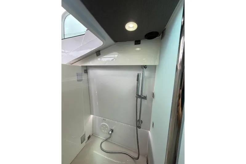  Yacht Photos Pics 2024 Axopar 37 Sun-Top interior shower with modern fixtures and sleek design.