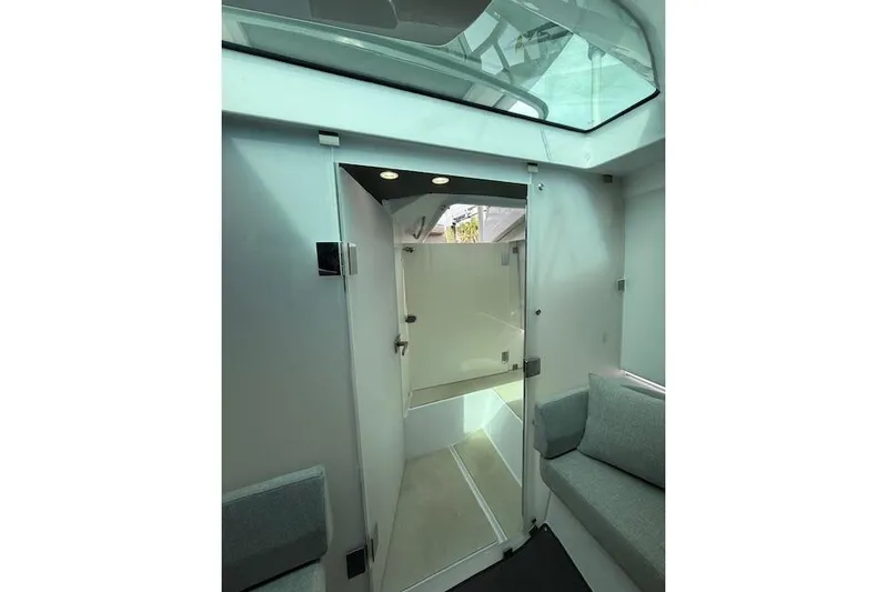  Yacht Photos Pics Interior view of 2024 Axopar 37 Sun-Top boat with skylight and seating area.