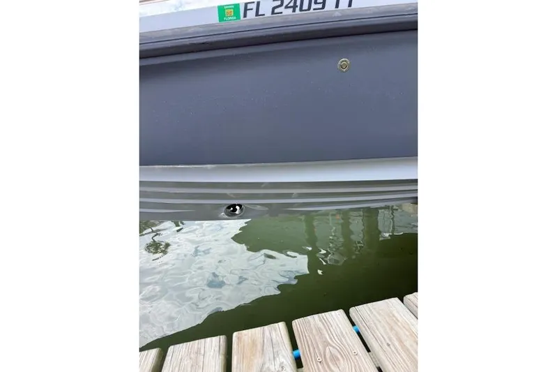  Yacht Photos Pics 2024 Axopar 37 Sun-Top boat hull near dock, Florida registration visible.