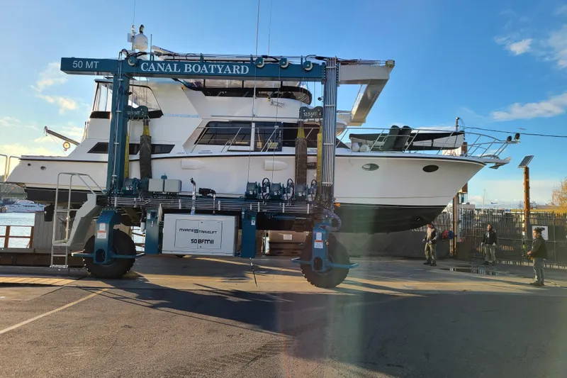 Outbound Yacht Photos Pics 1993 Symbol 55 Yachtfisher lifted at Canal Boatyard under clear blue sky.