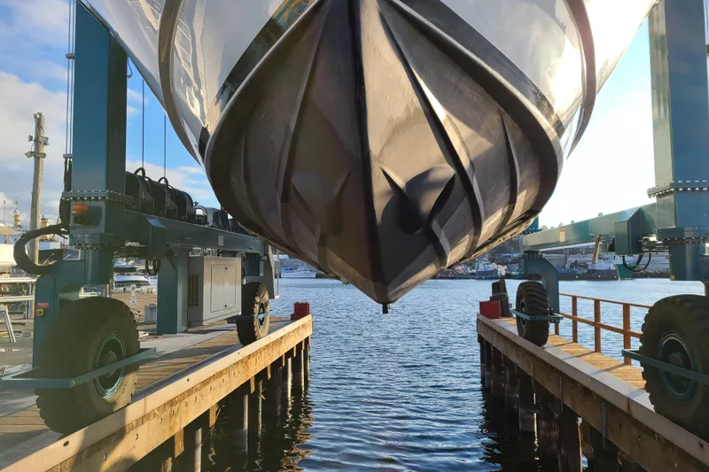 Outbound Yacht Photos Pics 1993 Symbol 55 Yachtfisher suspended over water at a marina.