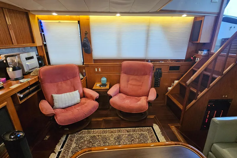 Outbound Yacht Photos Pics Interior of 1993 Symbol 55 Yachtfisher with cozy seating and wooden accents.
