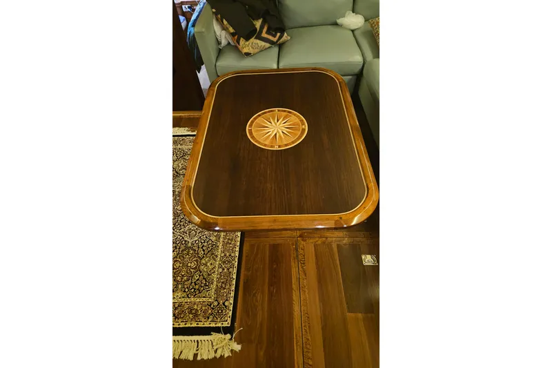 Outbound Yacht Photos Pics Luxurious wooden table with intricate inlay design on a 1993 Symbol 55 Yachtfisher.