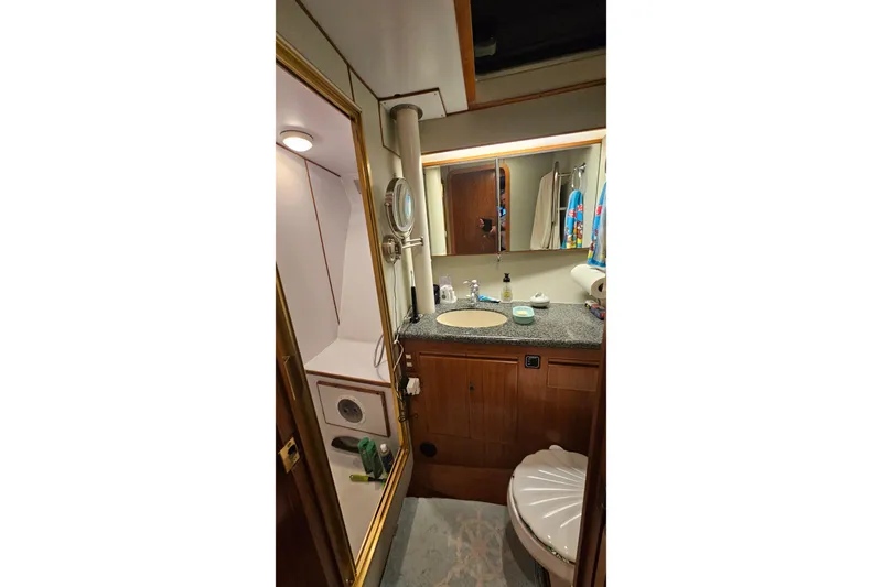 Outbound Yacht Photos Pics Bathroom interior of 1993 Symbol 55 Yachtfisher with sink, mirror, and shower.
