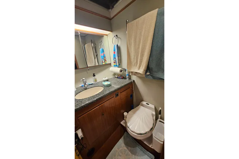 Outbound Yacht Photos Pics Bathroom interior of 1993 Symbol 55 Yachtfisher with sink, mirror, and toilet.