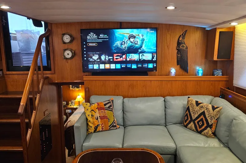 Outbound Yacht Photos Pics Luxurious 1993 Symbol 55 Yachtfisher interior with cozy seating and entertainment system.