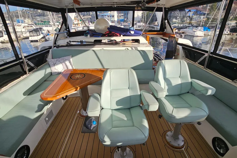 Outbound Yacht Photos Pics Interior of 1993 Symbol 55 Yachtfisher with seating, table, and marina view.