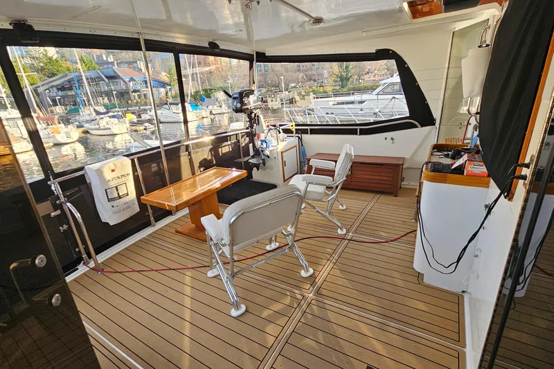 Outbound Yacht Photos Pics 1993 Symbol 55 Yachtfisher interior with seating, table, and marina view.